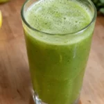 Light green celery apple mint juice in a tall glass