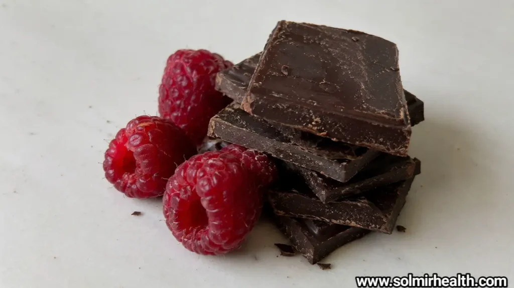 Healthy dessert snacks including chocolate yogurt bark, peanut butter oat bites and cocoa dusted date bites arranged in speckled ceramic bowls