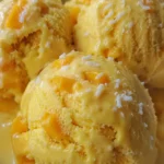 Mango coconut ice cream scooped into a bowl