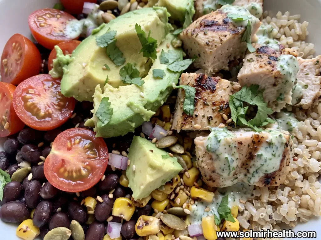 Chicken avocado bowl with sliced chicken, avocado, cherry tomatoes, cucumber, feta and lettuce
